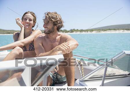 Couple sitting on boat together View Large Photo Image Stock Image - Couple sitting on boat together . Fotosearch