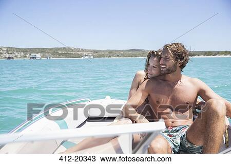 Couple sitting on boat together View Large Photo Image Stock Image - Couple sitting on boat together. Fotosearch