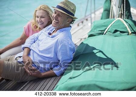Couple sitting on boat together View Large Photo Image Stock Photo - Couple sitting on boat together . Fotosearch