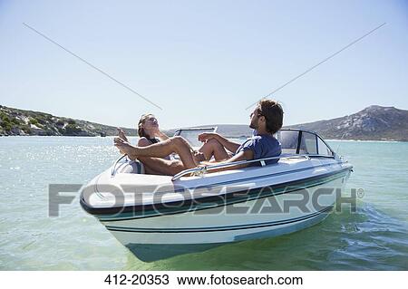 Couple sitting together in boat on water View Large Photo Image Stock Image - Couple sitting together in boat on water . Fotosearch