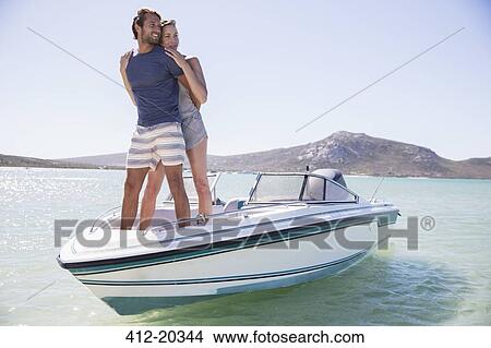 Picture - Couple standing on boat together. Fotosearch