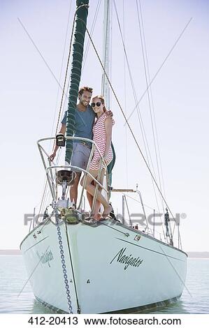 Couple standing on front of boat View Large Photo Image Stock Image - Couple standing on front of boat . Fotosearch