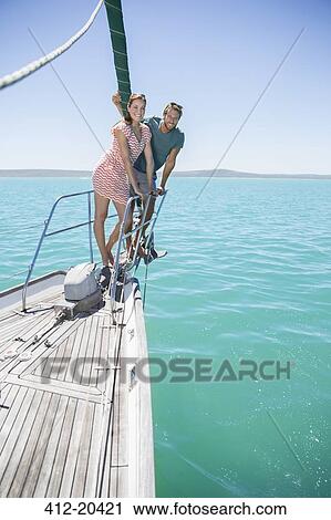 Couple standing on front of sailboat View Large Photo Image Stock Image - Couple standing on front of sailboat . Fotosearch