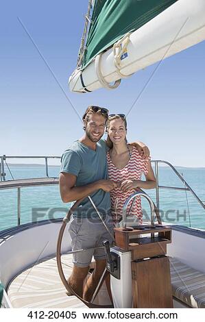 Couple steering sailboat together View Large Photo Image Stock Photography - Couple steering sailboat together . Fotosearch