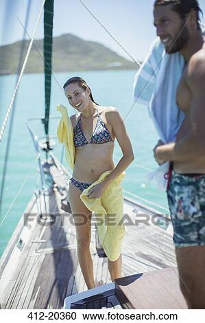 Couple toweling off on boat in water View Large Photo Image Stock Image - Couple toweling off on boat in water . Fotosearch