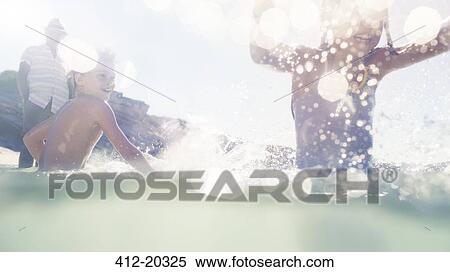Family playing together in water View Large Photo Image Stock Photography - Family playing together in water . Fotosearch