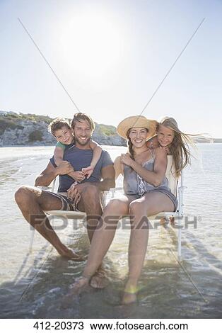 Family sitting in chairs in waves View Large Photo Image Stock Image - Family sitting in chairs in waves. Fotosearch