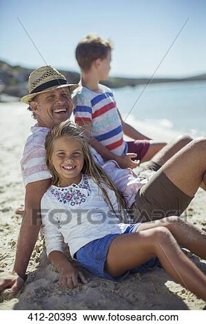 Family sitting in sand together View Large Photo Image Stock Image - Family sitting in sand together. Fotosearch
