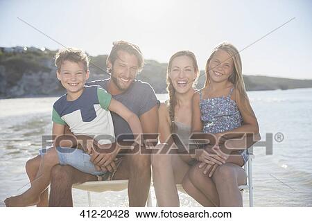 Family sitting together in waves View Large Photo Image Stock Photo - Family sitting together in waves. Fotosearch