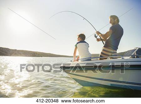 Stock Photo - Father and son fishing on boat . Fotosearch