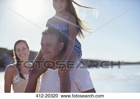 Father holding daughter on shoulders on beach View Large Photo Image Stock Image - Father holding daughter on shoulders on beach. Fotosearch