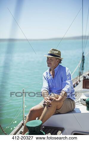 Older man sitting on boat outdoors View Large Photo Image Stock Photo - Older man sitting on boat outdoors. Fotosearch