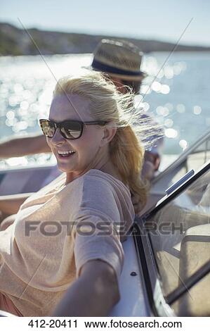 Older woman relaxing in boat with family View Large Photo Image Stock Image - Older woman relaxing in boat with family . Fotosearch