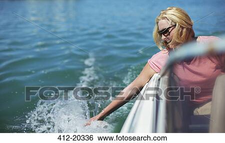 Older woman trailing hand in water from boat View Large Photo Image Stock Photograph - Older woman trailing hand in water from boat. Fotosearch
