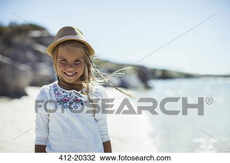 Young girl smiling on beach View Large Photo Image Stock Image - Young girl smiling on beach. Fotosearch