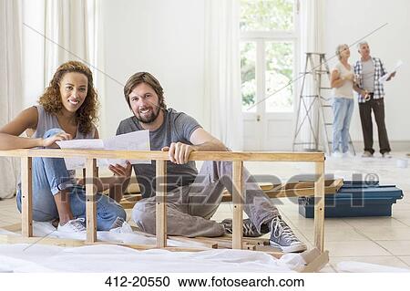 Couple building furniture together View Large Photo Image Stock Image - Couple building furniture together. Fotosearch