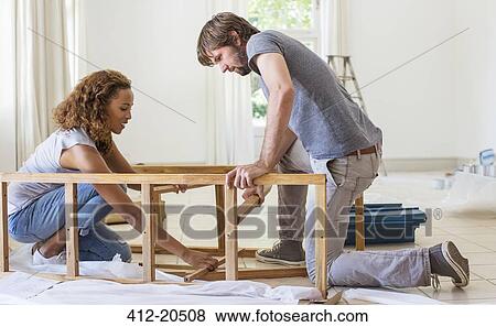 Couple building furniture together View Large Photo Image Stock Photo - Couple building furniture together . Fotosearch