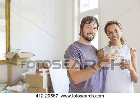 Stock Photo - Couple celebrating with drinks . Fotosearch