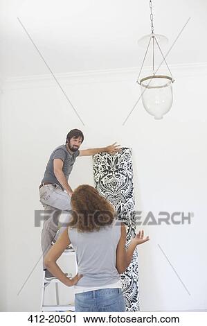 Couple deciding on wallpaper on wall View Large Photo Image Stock Image - Couple deciding on wallpaper on wall . Fotosearch