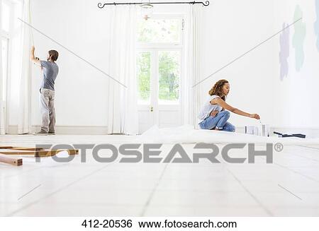 Couple fixing up new home View Large Photo Image Stock Photograph - Couple fixing up new home . Fotosearch