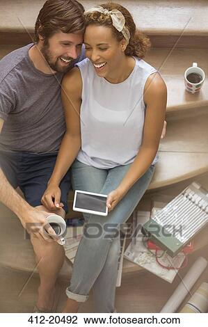 Couple laughing together on stairs View Large Photo Image Stock Image - Couple laughing together on stairs . Fotosearch