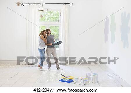 Couple looking at paint swatches together View Large Photo Image Stock Photo - Couple looking at paint swatches together . Fotosearch