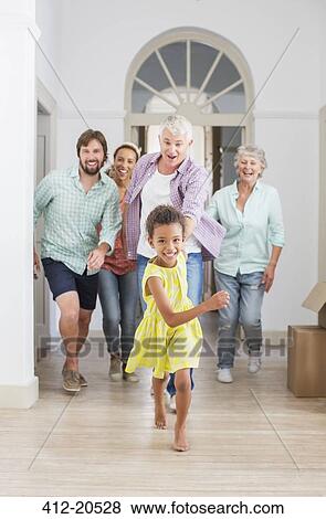 Family running through home together View Large Photo Image Stock Photo - Family running through home together. Fotosearch