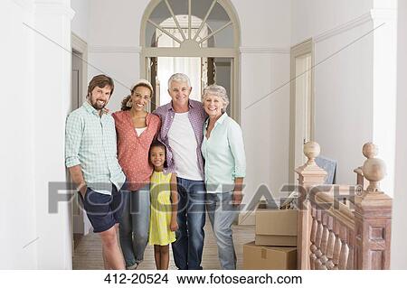 Picture - Family smiling together in living space . Fotosearch