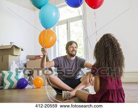 Father and daughter playing with balloons View Large Photo Image Stock Photo - Father and daughter playing with balloons . Fotosearch