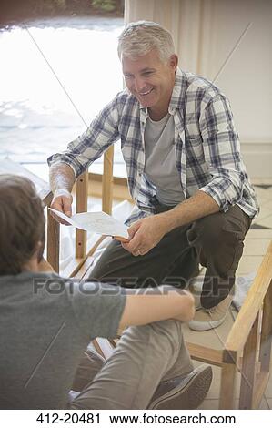 Father and son building furniture from instructions View Large Photo Image Stock Image - Father and son building furniture from instructions . Fotosearch