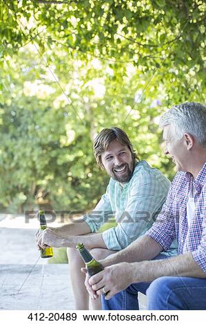 Father and son drinking outdoors View Large Photo Image Stock Photo - Father and son drinking outdoors . Fotosearch