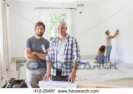 Father and son looking through construction plans View Large Photo Image Stock Photo - Father and son looking through construction plans . Fotosearch