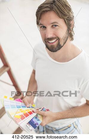 Man looking through color swatches View Large Photo Image Stock Photography - Man looking through color swatches . Fotosearch