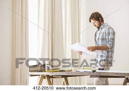 Man looking through documents View Large Photo Image Stock Image - Man looking through documents. Fotosearch