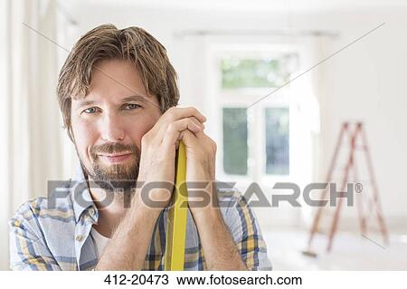 Man smiling in living space View Large Photo Image Stock Image - Man smiling in living space. Fotosearch