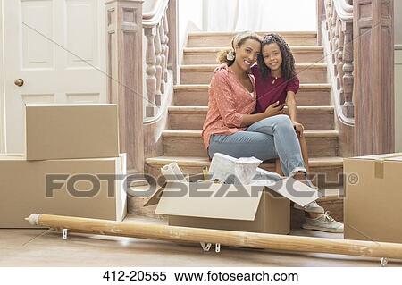 Mother and daughter hugging on stairs View Large Photo Image Stock Photography - Mother and daughter hugging on stairs. Fotosearch