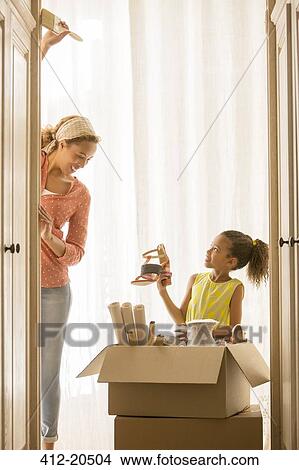 Mother and daughter unpacking boxes View Large Photo Image Picture - Mother and daughter unpacking boxes . Fotosearch
