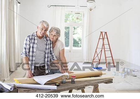 Stock Photo - Older couple looking through documents together. Fotosearch