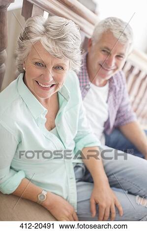 Older couple sitting together on stairs View Large Photo Image Stock Image - Older couple sitting together on stairs . Fotosearch