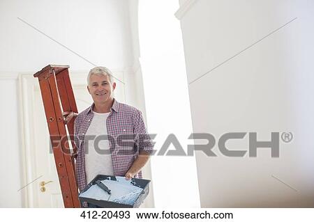 Older man carrying ladder and paint tray View Large Photo Image Stock Image - Older man carrying ladder and paint tray . Fotosearch