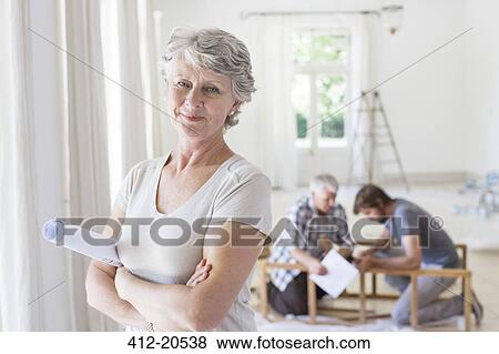 Older woman holding construction plans View Large Photo Image Stock Photo - Older woman holding construction plans . Fotosearch