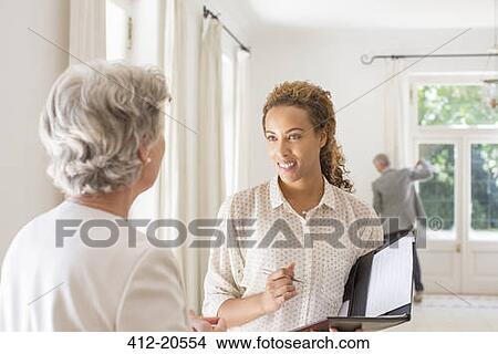 Two women chatting in living space View Large Photo Image Picture - Two women chatting in living space . Fotosearch