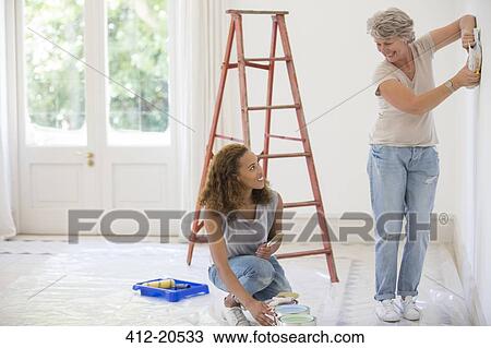Two women deciding on wall color together View Large Photo Image Stock Image - Two women deciding on wall color together . Fotosearch