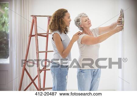 Two women deciding on wall color together View Large Photo Image Stock Photo - Two women deciding on wall color together . Fotosearch