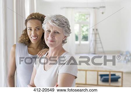 Stock Photo - Two women smiling together. Fotosearch