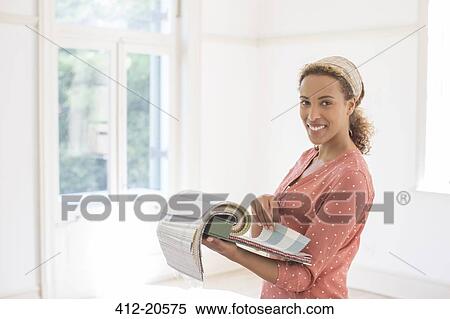 Woman looking through fabric swatches View Large Photo Image Stock Photography - Woman looking through fabric swatches. Fotosearch