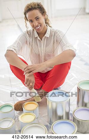 Woman overlooking space with paint cans near View Large Photo Image Picture - Woman overlooking space with paint cans near . Fotosearch