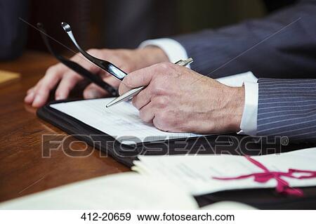 Stock Photo - Close up of lawyers hands in courtroom. Fotosearch