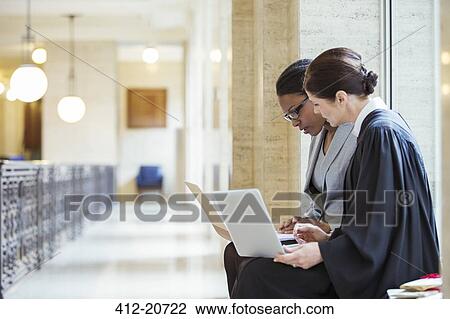 Judge and lawyer examining documents together View Large Photo Image Stock Image - Judge and lawyer examining documents together. Fotosearch