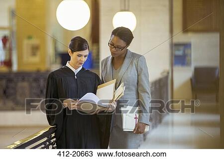 Judge and lawyer looking through documents View Large Photo Image Stock Image - Judge and lawyer looking through documents. Fotosearch
